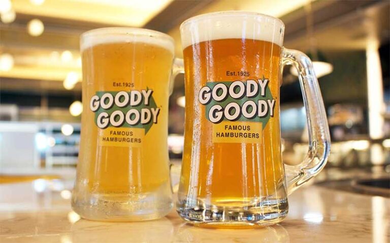 two draft beers in branded glass mugs at goody goody burgers tampa