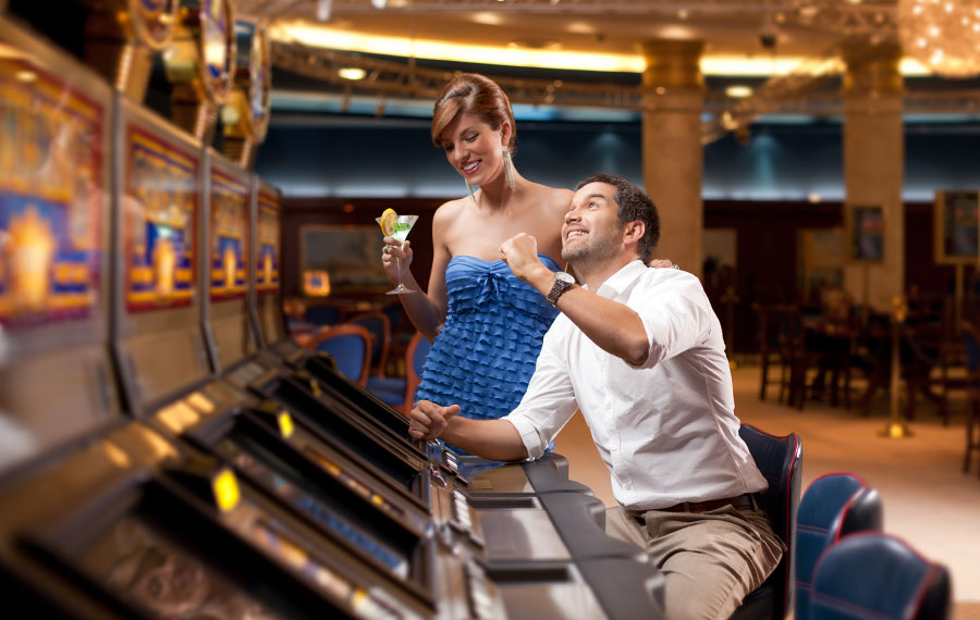 well dressed man and woman playing the slot machines at seminole hard rock casino hollywood fl