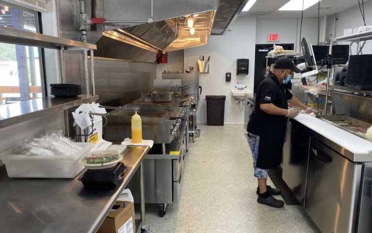 chef cooking in stainless kitchen at taco bus tampa