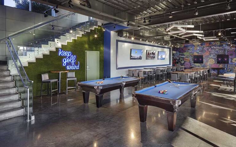 downstairs lounge with pool tables at topgolf tampa