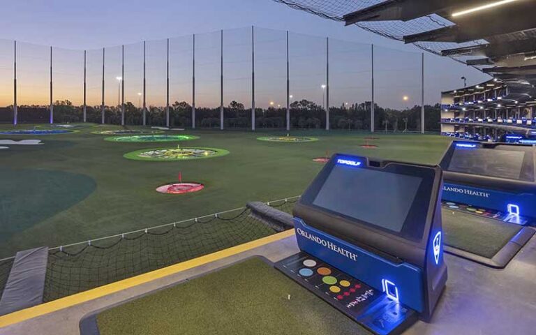 ground floor bays with hole targets and driving station at topgolf tampa
