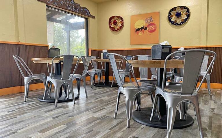 indoor dining area with tables and chairs at taco bus tampa