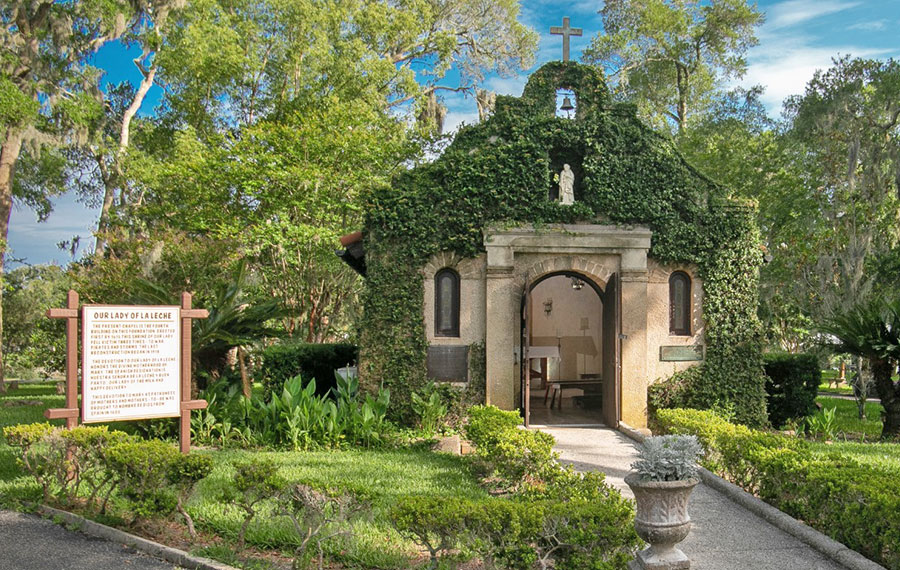 ivy covered chapel with plaque and surrounding trees and garden at national shrine of our lady of la leche st augustine