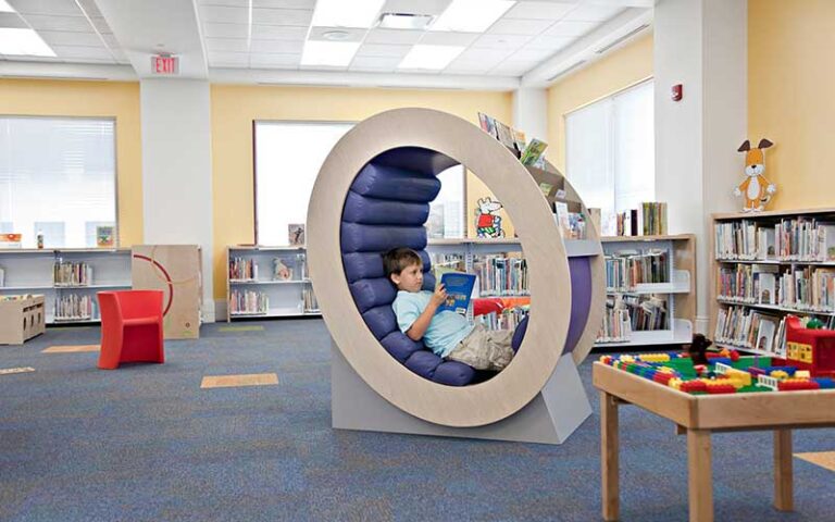 kids reading area with book shelves lego table and boy in reading nook at mandel public library of west palm beach