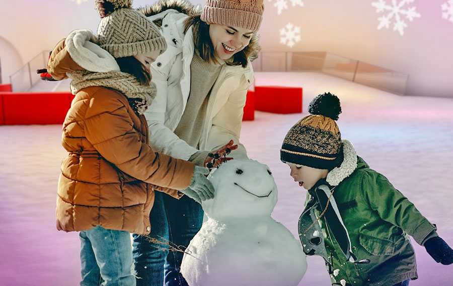 mom and kids in winter clothes making snowman at snowcat ridge dade city tampa