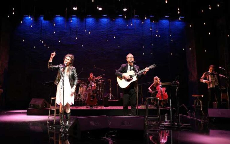 music group on stage with woman singing at straz center for the performing arts tampa