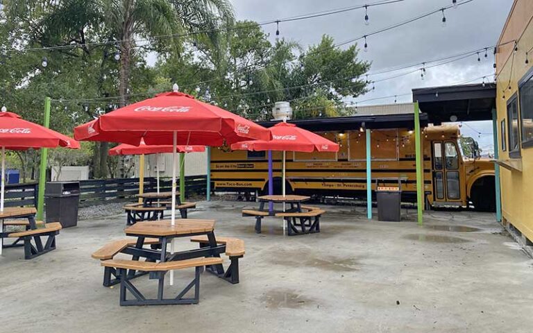 patio dining with red umbrellas at taco bus tampa
