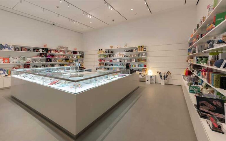 shop area with glass case and shelves with art pieces at norton museum of art west palm beach