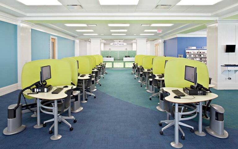 two rows of computer desks with info desk at mandel public library of west palm beach
