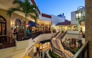 two story outdoor shopping at twilight with crowds at esplanade palm beach