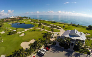 aerial over clubhouse of golf course and ocean at palm beach par 3 golf course