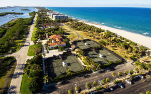 aerial view over park with tennis courts and beach at phipps ocean park palm beach