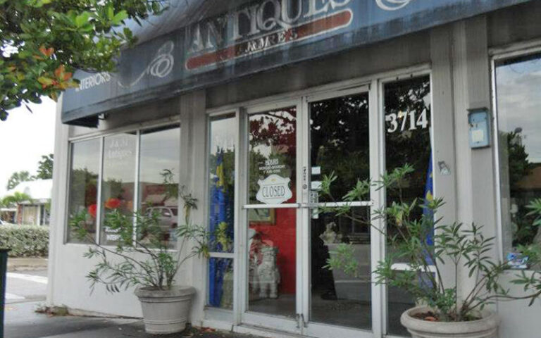 antique store with awning and entrance shaded by trees at west palm beach antique row art design district