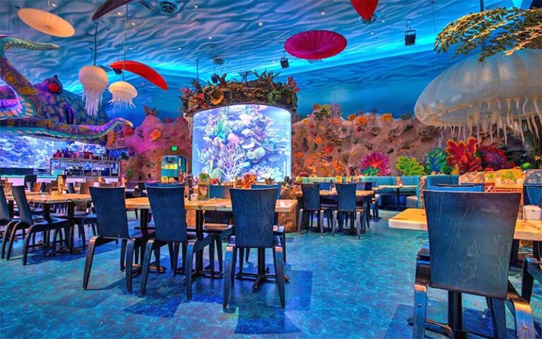 dining room with ocean theme decor and aquarium at t rex cafe disney springs orlando