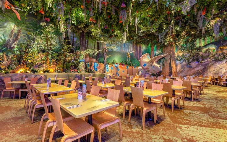 dining room with rainforest and triceratops at t rex cafe disney springs