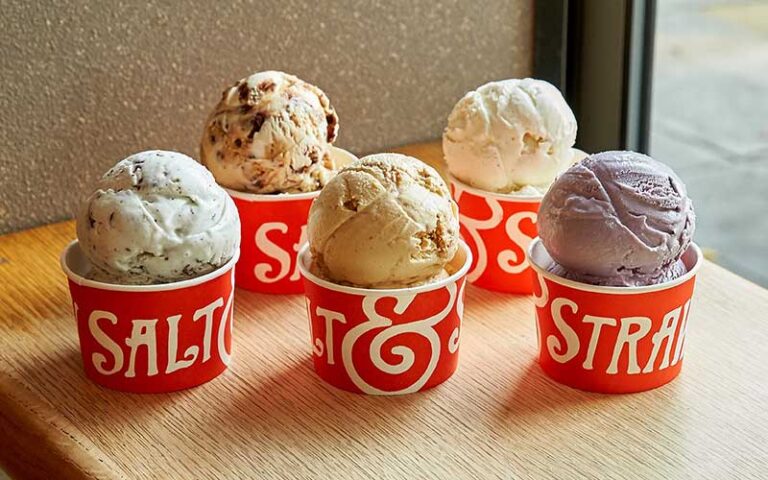 five different flavor ice cream scoops in red cups on windowsill at salt and straw cocowalk miami