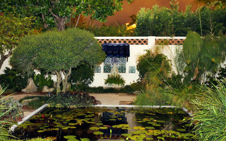 fountain wall with tile mural and lily pond at society of the four arts palm beach