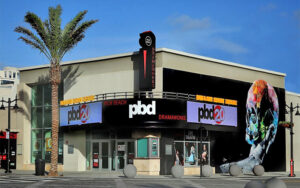 front entrance corner daytime exterior of theater with marquee and palms at palm beach dramaworks west palm beach