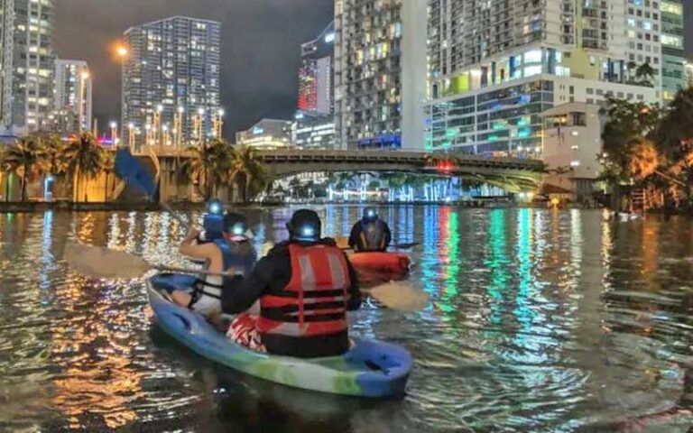 kayakers on bay downtown with lighted buildings at night at so flo water adventures miami