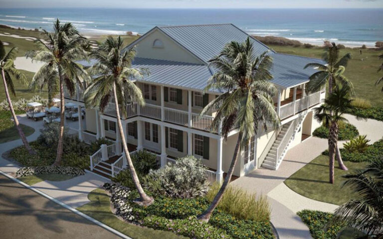 key west style clubhouse with verandas and ocean behind at palm beach par 3 golf course