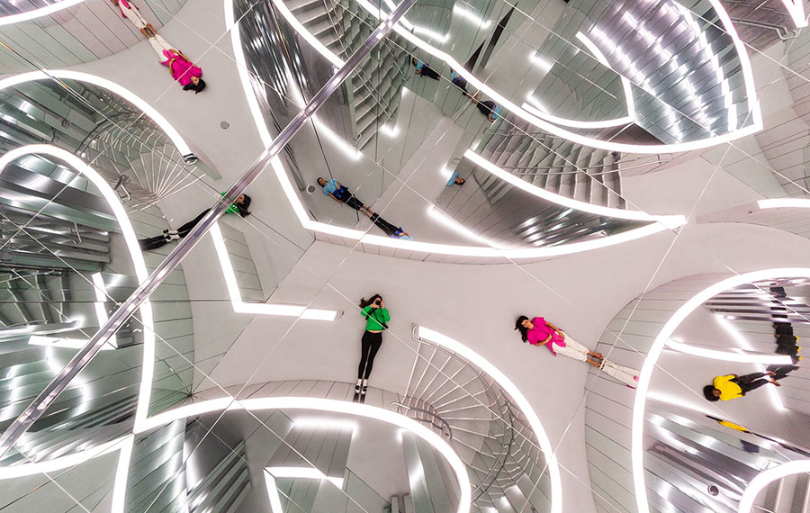 mirror maze art installation with girls posing and reflected at superblue miami