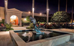 night exterior of museum with sculpture fountain at society of the four arts palm beach