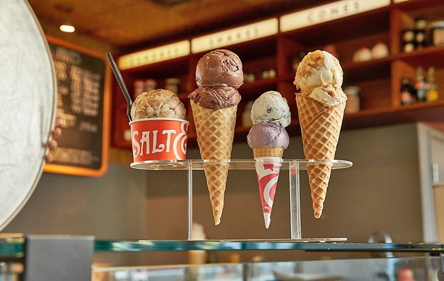 selection of wafflecones and cup of different flavors of ice cream on rack counter at salt and straw cocowalk miami