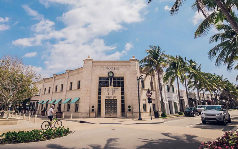 tiffany store front with stone facade on street with parking at worth avenue palm beach