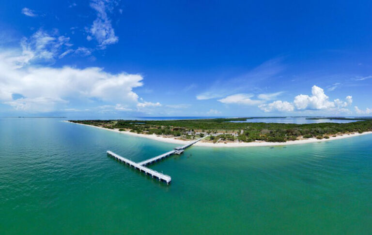 aerial fish eye view of island with long pier and clear sky at fort de soto park st pete