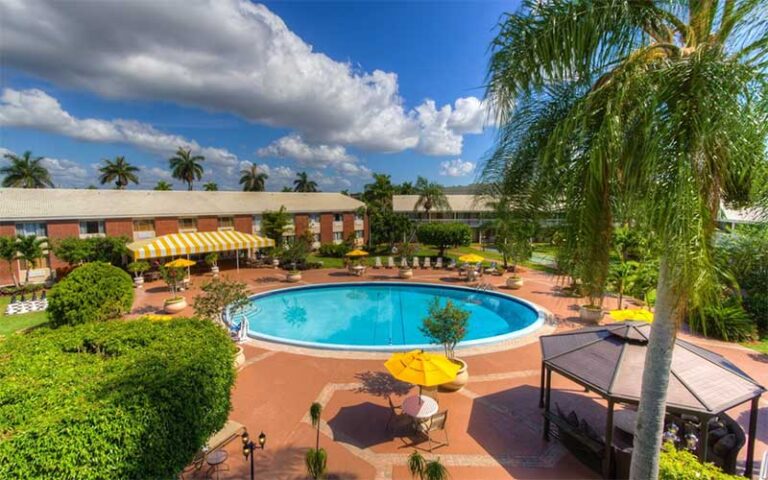 aerial view of round pool and buildings at best western palm beach lakes