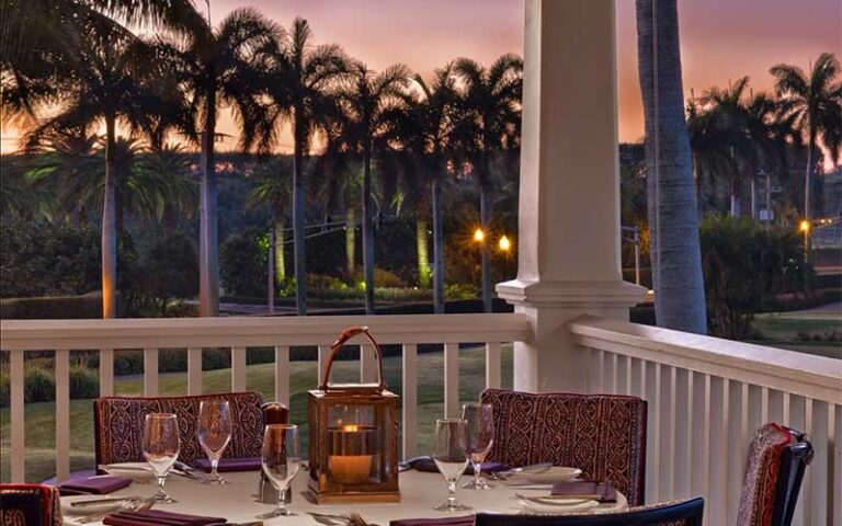 balcony dining table overlooking golf course at sunset at flagler steakhouse palm beach