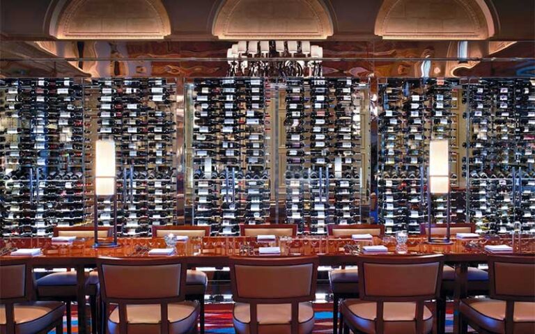bar area with wall of wine bottles and glass at hmf the breakers palm beach