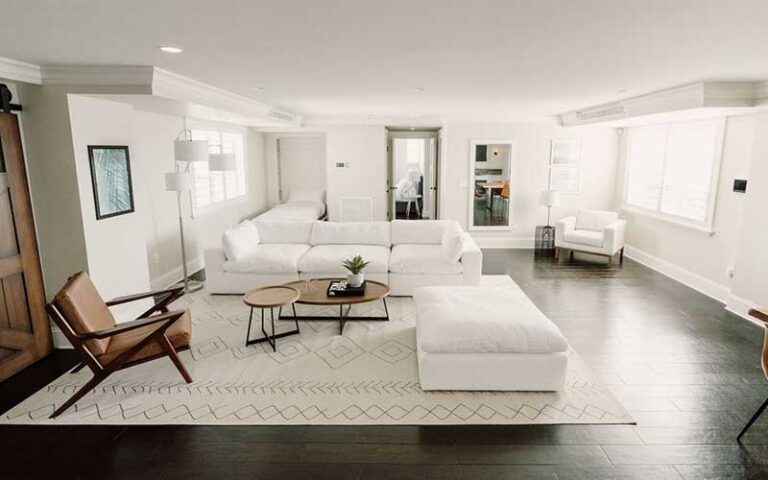 clean white furnished living space apartment at the ambassador palm beach hotel residences