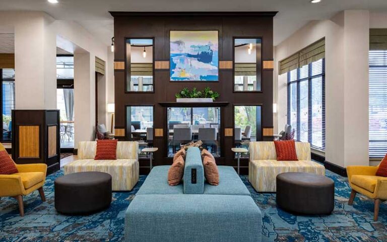 colorful lobby with comfortable seating at hilton garden inn west palm beach airport