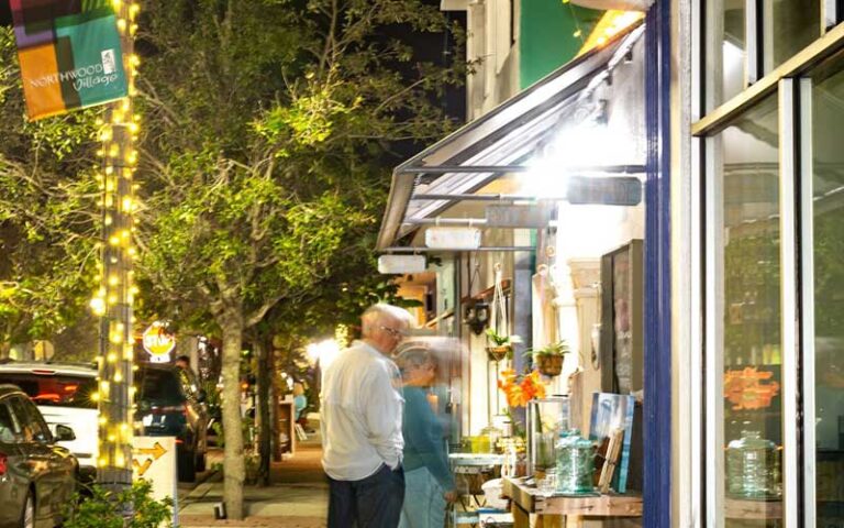 couple shopping stores along street at northwood village west palm beach