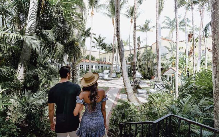 couple walking into courtyard at the brazilian court hotel palm beach