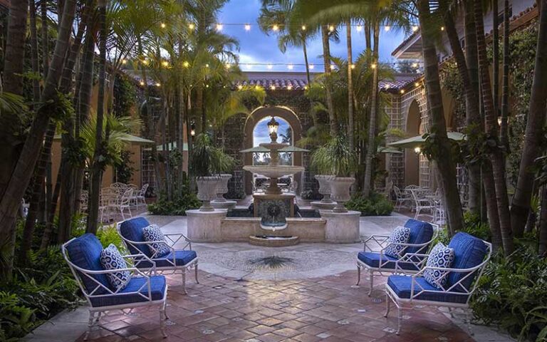 courtyard garden area with moonlight and fountain at the breakers palm beach