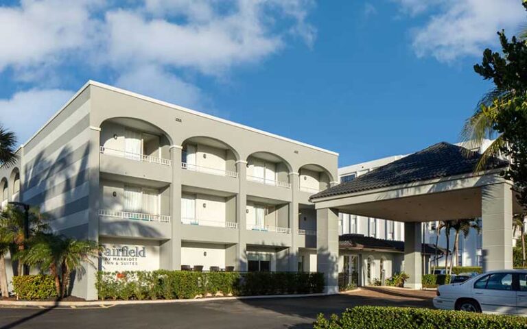 daytime exterior of hotel with entrance at fairfield inn suites palm beach