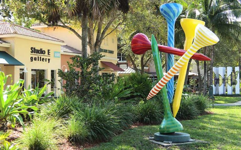 daytime view of golf tee sculpture with shops at pga commons art dining district palm beach gardens