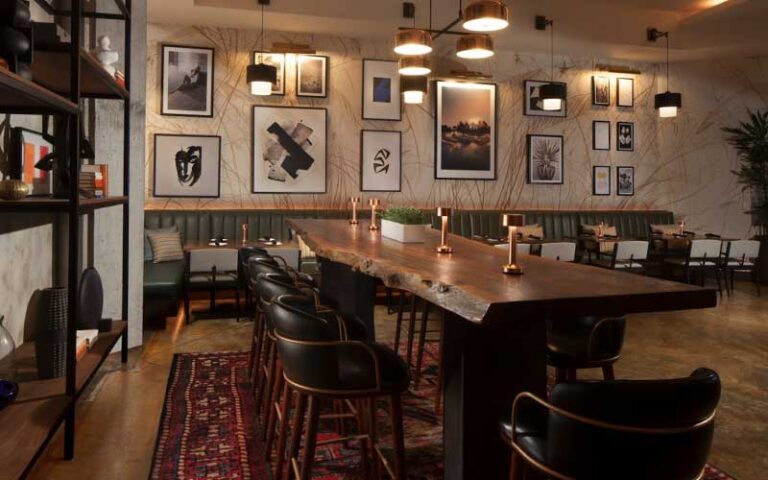 dining room interior with wood accents and bar tables at galley west palm beach