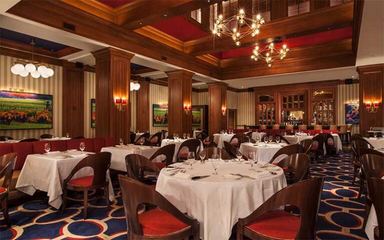 elegant dining room with atrium and red accents at flagler steakhouse palm beach