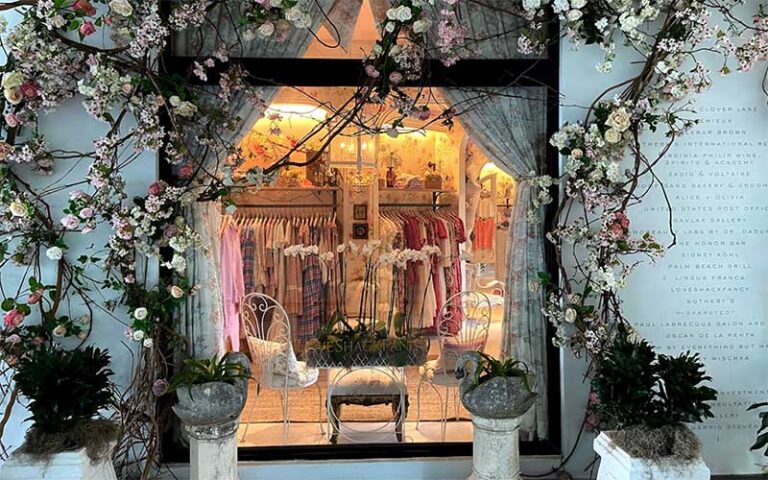 fashion store window with rose vine growing on wall at the royal poinciana plaza palm beach