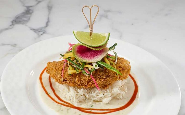 fish and rice with garnish at seafood bar the breakers palm beach