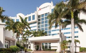 front exterior daytime high rise hotel with entrance and sign at west palm beach marriott