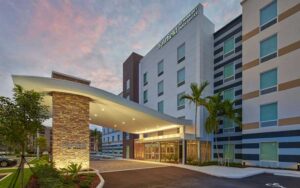 front exterior of hotel with twilight at fairfield inn suites by marriott west palm beach