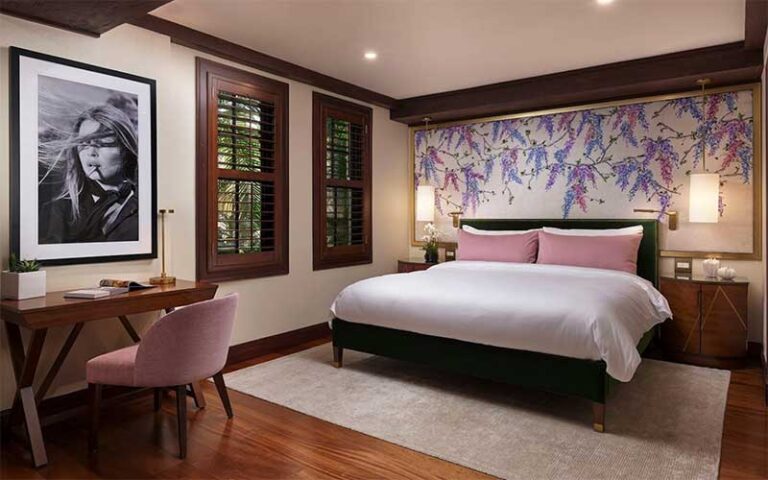 guest room with king bed and wood accents at the brazilian court hotel palm beach