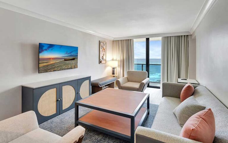 guest room with ocean view sofa and chair at tideline palm beach ocean resort spa