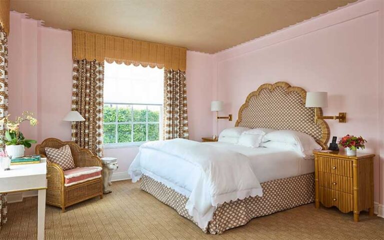 guest room with pink and gold accents at the colony palm beach