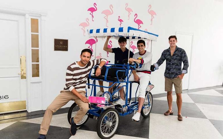 guys sitting in surrey bike at the royal poinciana plaza palm beach