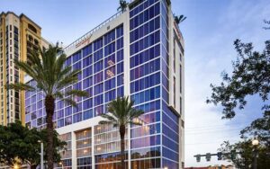 high rise hotel with blue windows at canopy by hilton west palm beach downtown